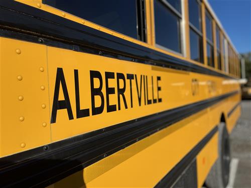 picture of school bus that is yellow with Albertville written on the side in black